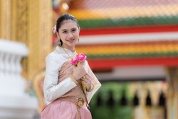 Portrait of a beautiful thai woman wearing a thai dress,Thai girl in retro Thai dress,Beautiful Thai girl in traditional dress costume