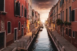 Scenic colorful Venice streets near landmark Rialto Bridge in historic city center.