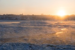 Extreme cold and sea fog moving on the St. Lawrence River seen at sunrise from Quebec City's old port, Quebec, Canada