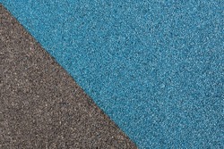 Blue and black rubber coating for playgrounds applied on the surface by a steel trowel. PDM rubber granules. Coating and floor covering for sports. Rubber mulch for safety and injury prevention