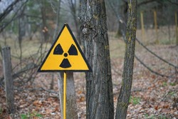 Nuclear radioactive danger sign in forest in Chernobyl exclusion zone around Chornobyl Nuclear Power Station