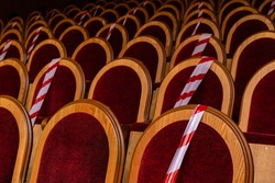 Restrictive tapes on the seats in the concert hall. Pandemic. Covid 19. Restrictive measures