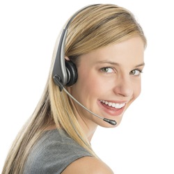 Close-up portrait of happy female customer service representative wearing headset isolated over white background