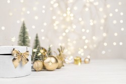 Christmas background , gift box with a Golden bow on the background of Christmas bokeh