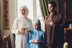 muslim caucasian family drinking tea. Enjoying in tea time at home.