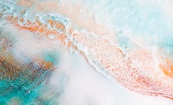 Artistic texture painted with liquid acrylic paints. Fluid art for background, wallpapper or poster. Backdrop similar to the landscape of the ocean. Sea artwork with turquoise waves and white foam.