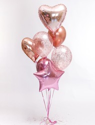 Stylish metallic pink balloons for Valentine's day, hen party or baby shower on a white background.