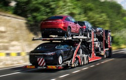Hauling cars. A car carrier trailer, known variously as a car-carrying trailer, car hauler, auto transport trailer.New and very expensive cars transportation. 
