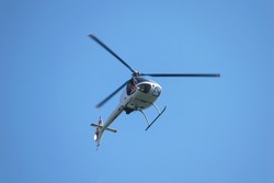 Small helicopter in flight. Helicopter for two people.
