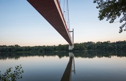Concrete bridge over water. Bridge over the Danube. Reflections in the water.