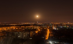 
full moon over night city