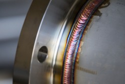 Steel weld joined pipe to plate by arc welding process . rainbow color.with copy space
