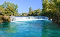 Manavgat. Waterfall on the Manavgat River in Antalya province. It is located near the ancient city of Side. Manavgat. Turkey. Antalya. A wide stream of water falls from a low height. Drone shooting