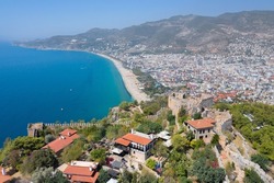 A view from above on the city of Alanya, the Ich Kale fortress and the Cleopatra beach. Fortress on the Chilarda-Burnu peninsula. Mediterranean Sea. Turkey. Aerial photography. Panorama of Alanya
