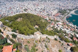 View from a height of the port and the city of Alanya, the Ich Kale fortress. Fortress wall. Fortress on the Chilarda-Burnu peninsula. Mediterranean Sea. Turkey. Aerial photography. Panorama of Alanya