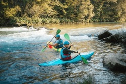 Two whitewater kayakers paddling on the waters of river. Adrenaline seekers and nature lovers.