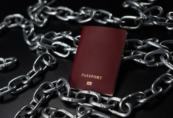 the passport of against the background of chains as a symbol of restrictions and sanctions