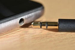 Standard audio jack and 3.5 mm jack on phone, close-up