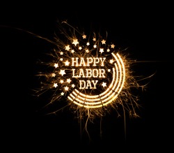 Happy Labor Day greeting done using sparklers on black background with copy space.