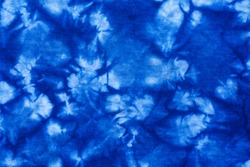 Pattern of blue tie batik dye on cotton cloth, Dyed indigo fabric background and textured