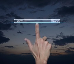 Hand pressing search www button over sunset sky, Searching system and internet concept