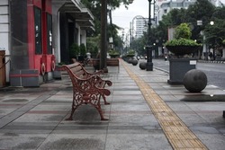 Pedestrian bench on the sidewalk of Jalan Braga, Bandung in the morning                      