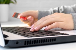 Hands on keyboard, woman enters data using a laptop. Online shopping or problems with a blocked credit card and account, rejected and invalid payment for purchases, financial fraud, theft or debt.