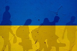 Ukraine flag on wall and refugee shadows. Ukraine war concept.