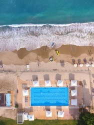 Aerial top View From Flying Drone Of People Crowd Relaxing On Beach with swimming pol In Bulgaria