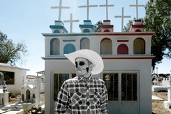A Dia de los Muertos - Day of the death - Cowboy Man with Catrin Makeup Strolling Through a Mexican Cemetery