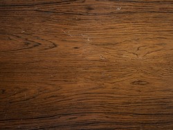 Dark stained wooden table background, rustic wood planks  texture top view. Woodworm attack.