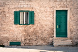Green window and green door on old traditional house in Sibenik Croatia