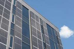 Modern building boasting a solar facade. Wall with solar panels on a modern building.