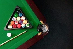 Billiard ball in the triangle on the billiard table, American billiards. Sports games, outdoor activities.