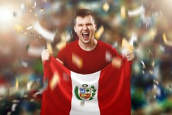 Peru is a fan, a fan of a man holding Peru's national flag in his hands. Soccer fan in the stadium.