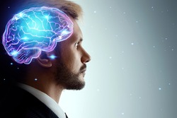 Close up portrait of a man from the side in profile and a hologram of a working brain. The concept of intelligence, brain work, thought process