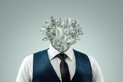 A businessman in a business suit with banknotes instead of a head, a head made of dollars. The concept of money addiction, working only for money, business, startup, career