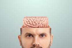 The concept of non-standard thinking and creativity., The male head is open from which the square brain is visible. Creative background, brain, fantasy, genius, creativity, not what it seems