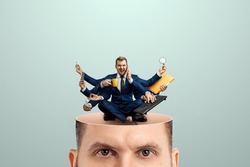 Instead of a brain, a man has a multi-armed businessman in his head. Creative picture, concept of multitasking, multi-hands, brain work, stress resistance