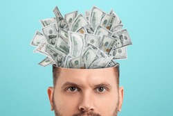 Business thinking, money, dollars sticking out of the mind of a man instead of a brain. Creative background, business concept, entrepreneurship, startup