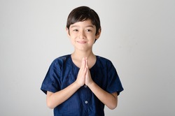 Little asian boy praying in Thai costume  isolate on white background