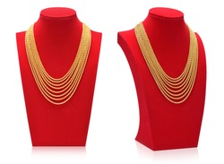 Gold necklaces on necklace display stand.
