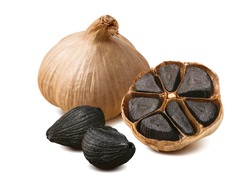 Black garlic bulbs and cloves isolated on white background. Package design composition with clipping path