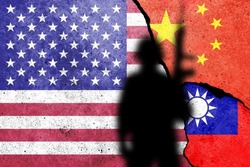 United States of America, China and Taiwan  flags painted on the concrete wall with soldier shadow. USA and China war and winning concept