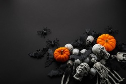 Creepy Halloween background - black bats and skulls on black.
