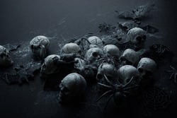 Creepy Halloween background - black bats and skulls on black.