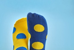 World Down syndrome day background. Legs with different socks as symbol of down syndrome