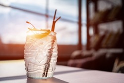 kamikaze cocktail in tiki glass with vodka, triple sec, lemon and cherry