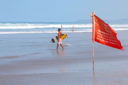 warning sign of a red flag at a beach