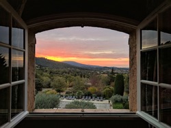 Window open on sunrise in Provence, France